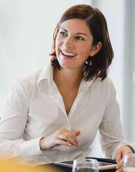Woman smiling looking to the left.
