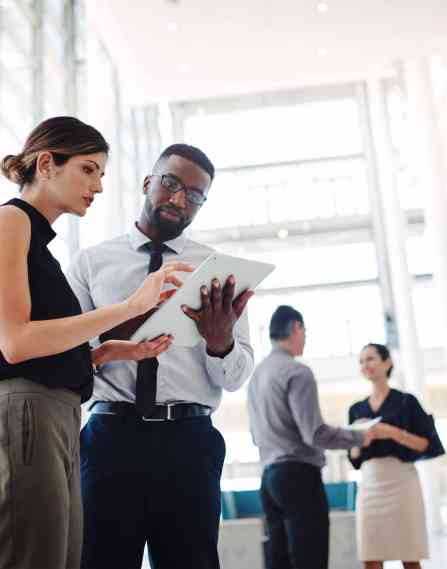 Shot of a young businessman and businesswoman using a digital tablet at a conference