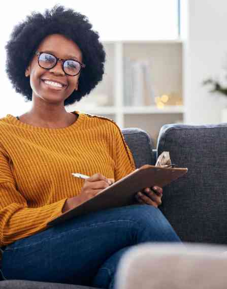 Woman holding a clipboard and smiling