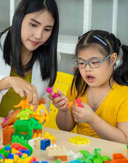 Teacher and student playing with toys