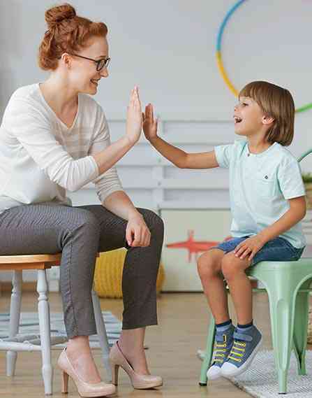 Teacher high fiving her student