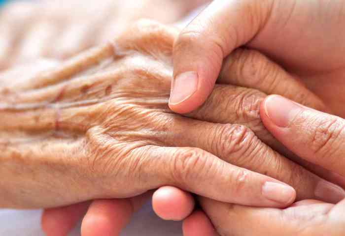 Adult gerontology nurse and patient hands.