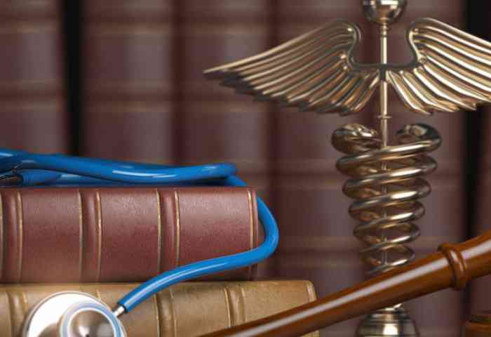 Medical book, stethoscope and gavel.