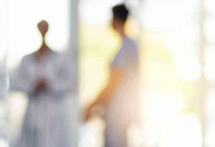 Blurred view of nurses and medical professionals.