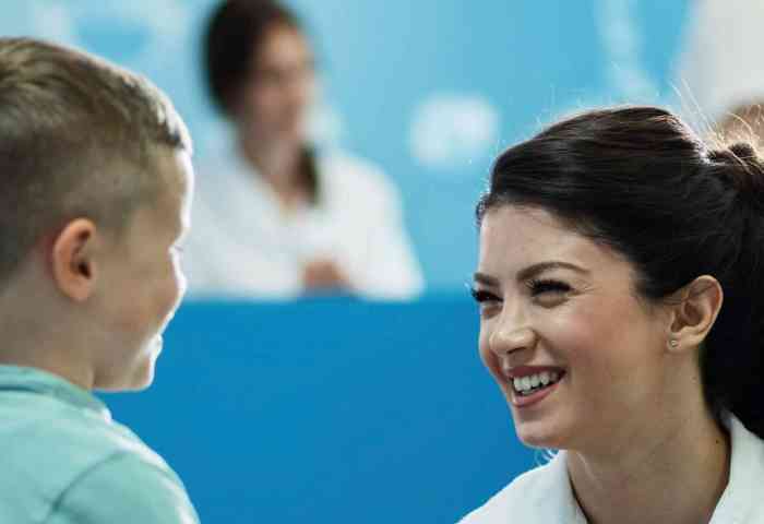 A nurse talking to a young patient.