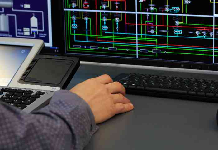 Close up of a person using a manufacturing control computer.
