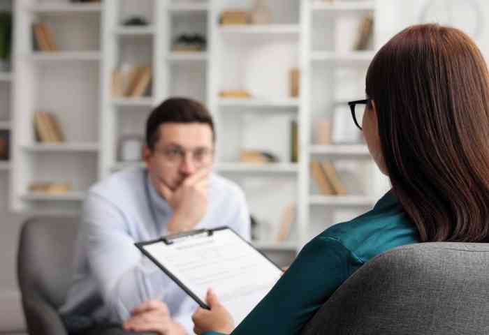 Two people talking at a desk