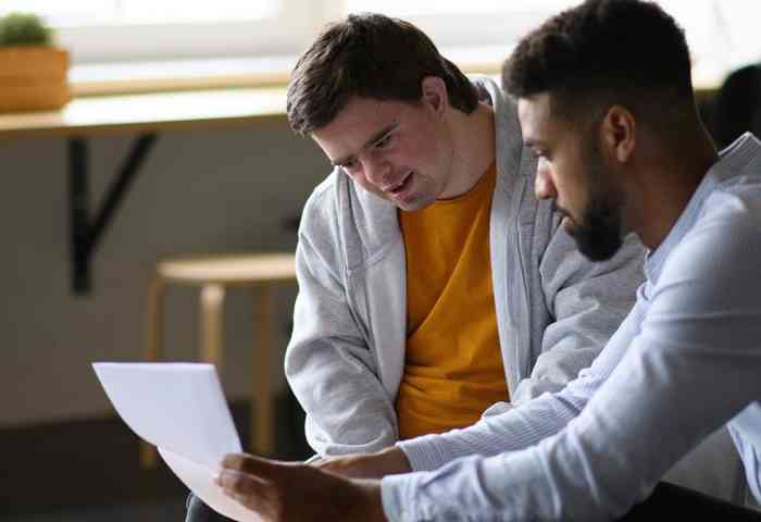 Analyst looks over paper with patient