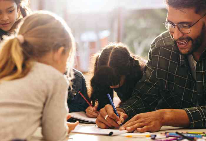 Students watching their teacher draw.