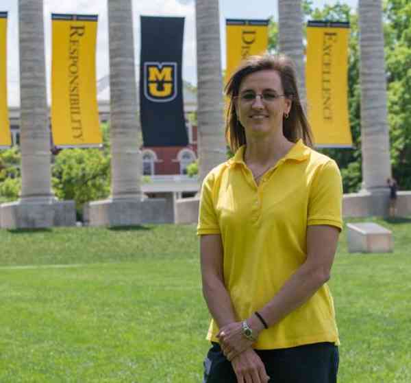 Paula Schuerer, biomedical sciences MS, stands on the Mizzou quad in front of the columns.