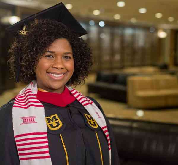 Cassandra Adams Jones, journalism MA, in her graduation cap and gown.