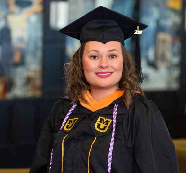 Callie Rinehart, MS in leadership in nursing and health care systems, wearing her graduation cap and gown.