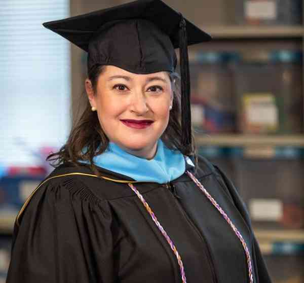 Amy Simons, Mizzou journalism professor and graduate, wearing her graduation cap and gown.