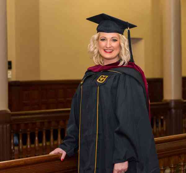 Brandi Sutherland, family and community services MA, in her graduation cap and gown.